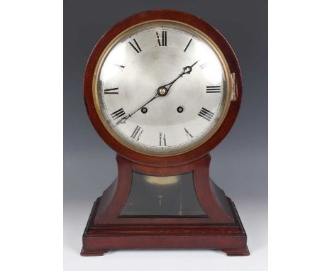 An early 20th century mahogany balloon cased mantel clock with eight day movement striking on two gongs, the backplate stampe