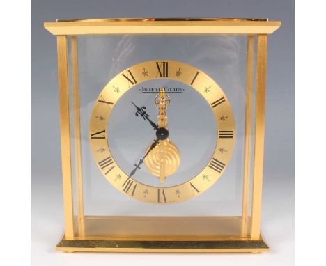 A Jaeger-LeCoultre gilt brass mantel timepiece, the brass chapter ring with black Roman hour numerals surrounding the signed 