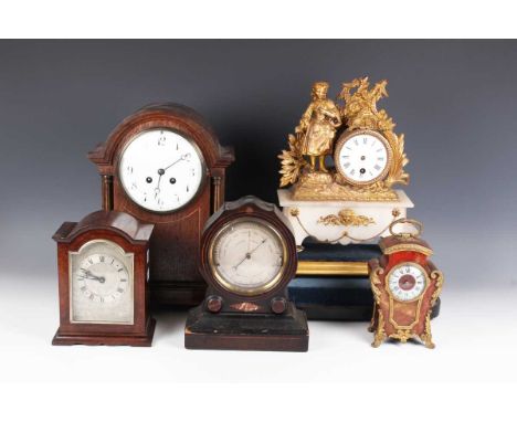 An early 20th century oak mantel clock with eight day movement striking on a gong, the white enamelled dial with black Arabic