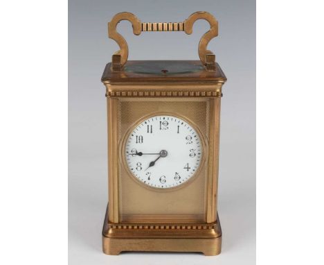 A late 19th/early 20th century lacquered brass carriage clock, the eight day movement striking hours and half hours and repea