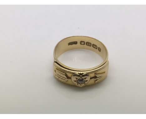 An 18ct gold ring opens with raised letters MIZPAH decorated with a central heart set with a small diamond, approx 5g and app