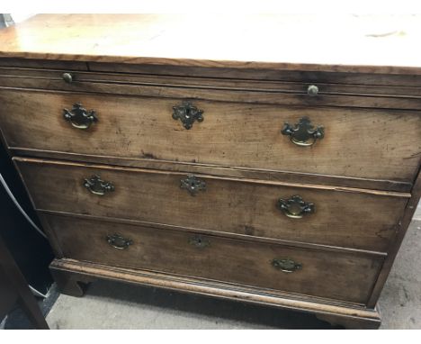 A mahogany chest of drawers the rectangular top above a brushing slide with three drawers under on bracket feet