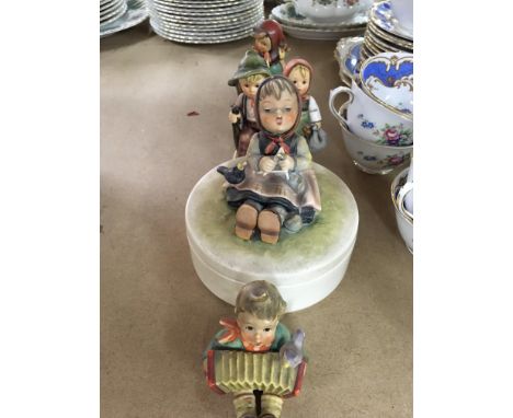 A goebel jar and cover and three figures
