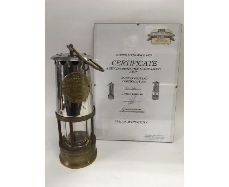 A Protector flame safety lamp together with a signed certificate.
