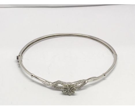A 9ct white gold and diamond hinged bangle, 7.1gr