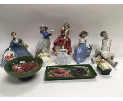 A small collection of ceramics including two Moorcroft dishes, Doulton, Nao, Coalport and Goebel figures.