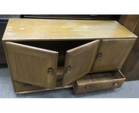 An Ercol, light wood sideboard.Approx 43x127x77cm high, some wear