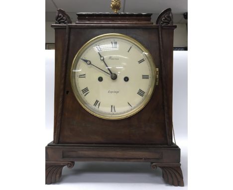 A regency mahogany case metal clock the enamel dial with Roman numerals with fusee movement striking on a bell maker Harris L