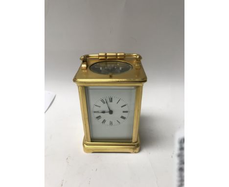 A brass gilt case  carriage clock with repeat button the dial with Roman numerals