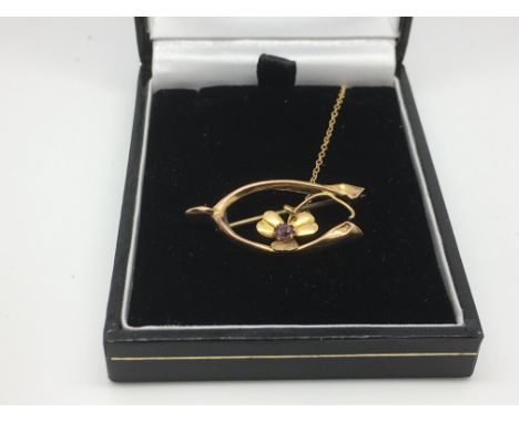 A gold brooch set with an amethyst, approx 1.6g.