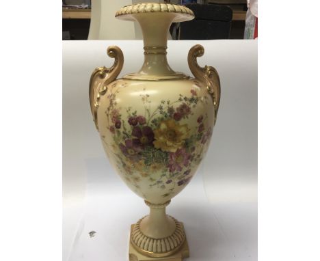 A large Royal Worcester vase hand painted with flowers and with gilt scroll handles. Hight 42cm