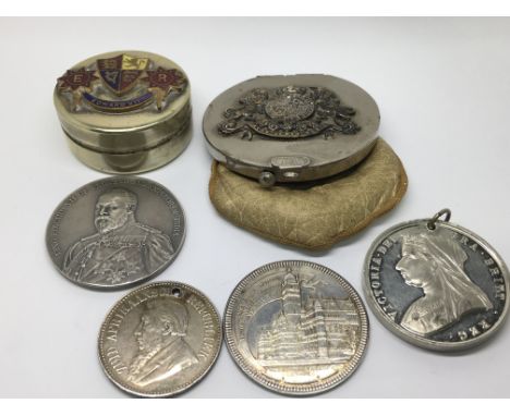 A leather and silver plated purse with an applied Royal coat of arms an Edward VII enamel box and commemorate medallions.