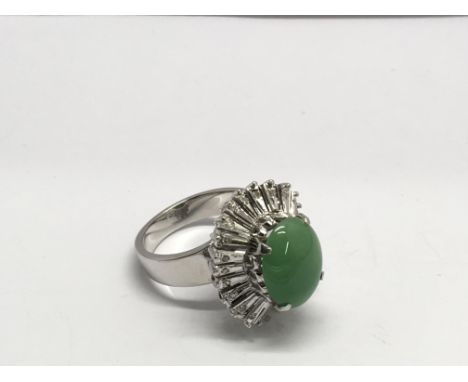 An 18k gold, diamond and jade cluster ring.Approx size M
