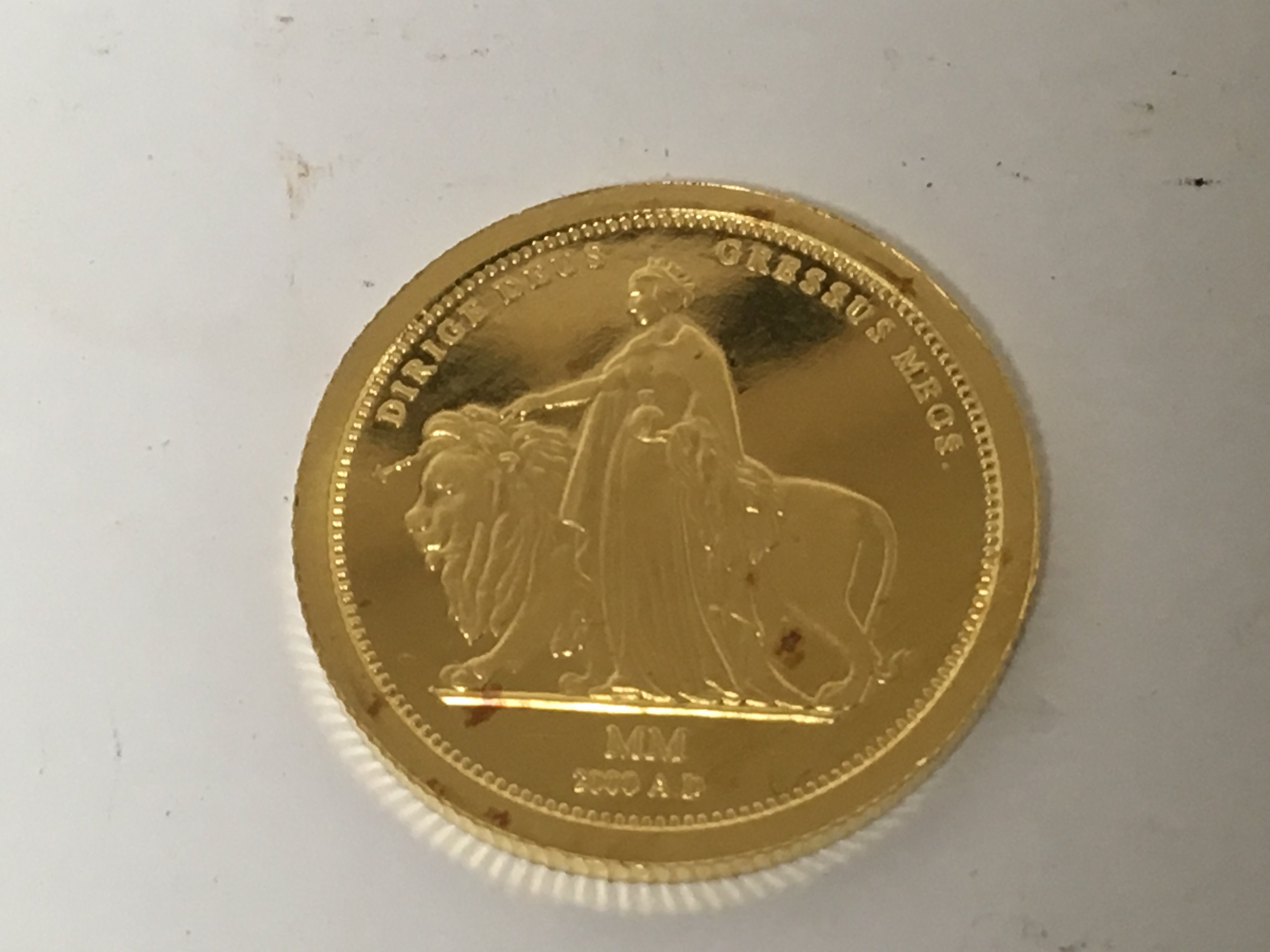 A pure gold 24carat coin Milestones of the Millennium. Weight 7.7g