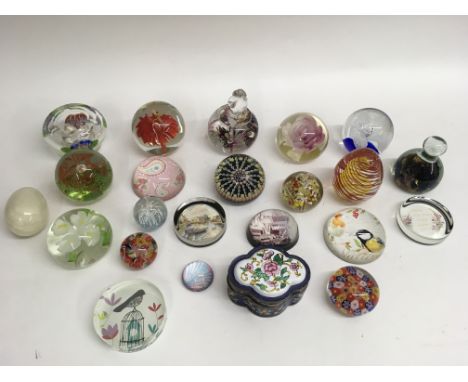 A collection of paperweights and an enamel trinket box