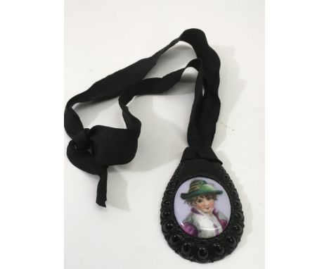 A Victorian style, jet portrait pendant on ribbon