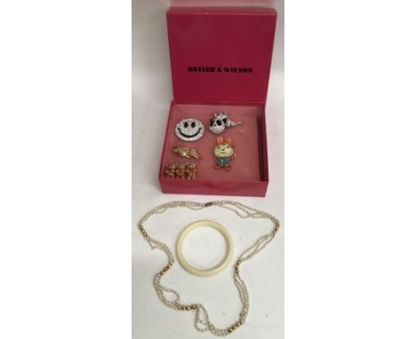 A collection of Butler&amp;Wilson brooches, a bangle and a double strand of seed pearls