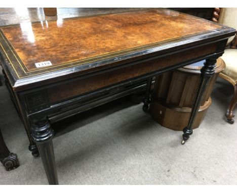 A Victorian burr walnut card table on turned fluted legs