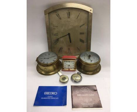 A circular brass barometer and matching clock, stopwatch, wall clock etc.
