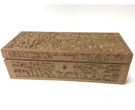 A carved wood sandalwood Chinese trinket box early 20th Century profusely carved with figures and buildings with an detachabl