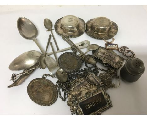 A collection of wine labels spoons enamel badges and other oddments.