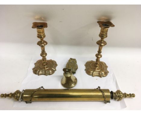 A pair of early 19th century brass candlesticks, a rolling pin, owl and bell