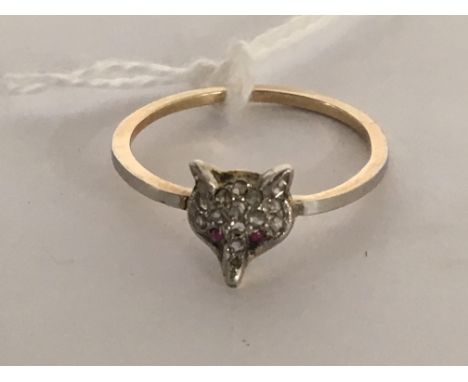 A 15ct gold ring in the form of a diamond set fox head with ruby eyes. Ring size R.