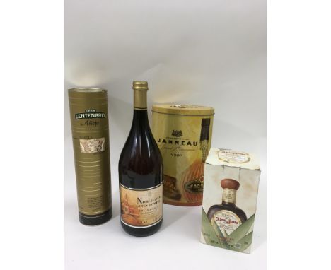 A tin containing a bottle of Janneau Grand Armagnac, a bottle of Gran Centenario tequila, another by Don Julio and a large bo