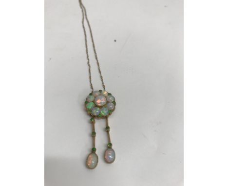 A Art Deco opal pendant with drops attached a 15 ct gold chain