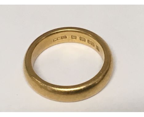 A 22 carat gold wedding band ring size M weight 9g.