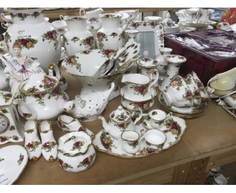 A collection of Royal Albert country Rose items including Telephone vases clock frame figure cups saucers and dishes