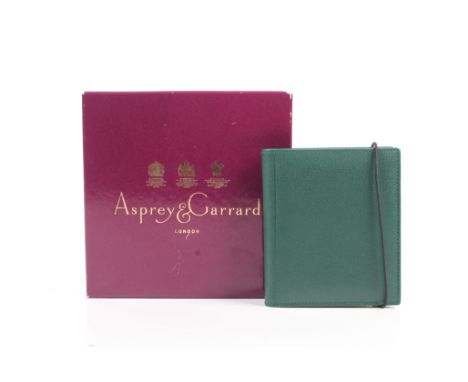 Asprey and Garrard, a green-leather bound note pad. Approx. 12.5cm x 11cm, In the original purple card box