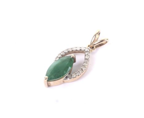 A vintage emerald and diamond pendant. The marquise shaped emerald claw set below a tiny eight-cut diamond 19 stone arch, sta