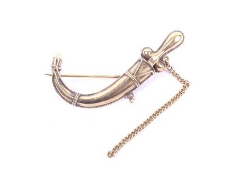 A vintage brooch in the form of a middle eastern style dagger in a sheath. The curved sheath decorated with wire-work, the re