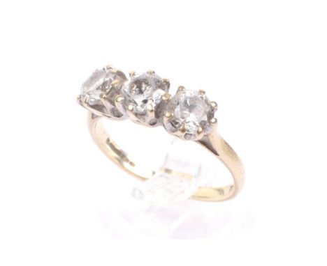 A vintage 9ct gold and cubic zirconia three stone ring. The three round stones claw set on a D-section shank with knife-edge 