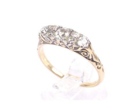 A late Victorian gold and diamond carved half-hoop ring. The three graduated old-cut stones approx. 0.75cts total, spaced by 
