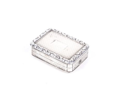 A late George III silver vinaigrette. Engine turned with a raised and floral chased border, flower and scroll pierced gilt gr