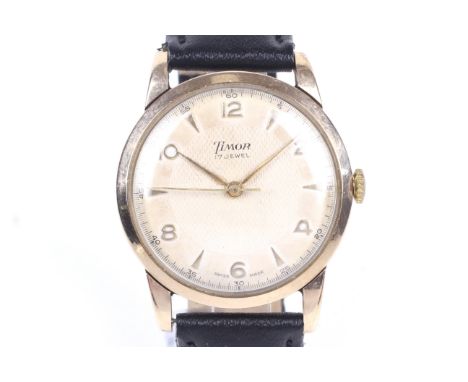 Timor, a gentleman's 9ct gold cased round wrist watch, circa 1956. The textured cream dial with raised gilt Arabic and arrow-