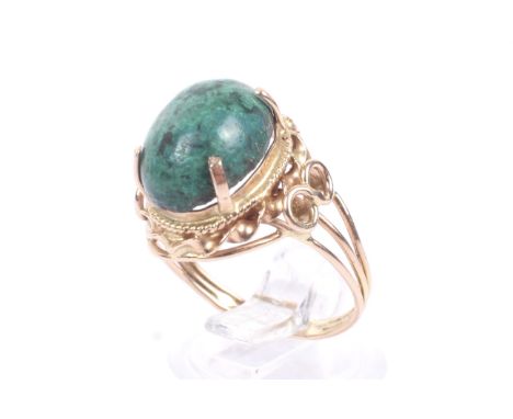 A vintage gold and azurite/malachite single stone ring. The oval cabochon azurite/malachite claw set on a rope-work and textu