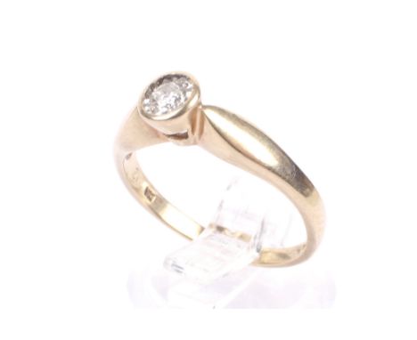 A vintage 9ct gold and diamond solitaire ring. The round brilliant approx. 0.15cts, grain set in white within a yellow gold c