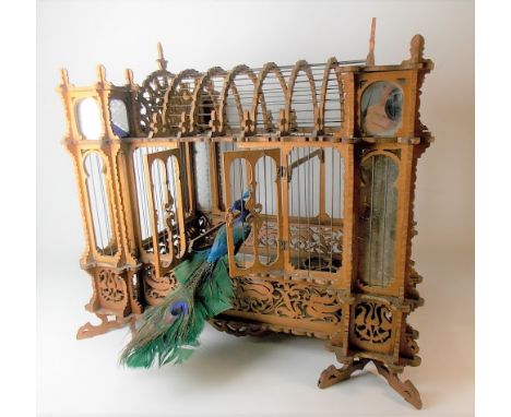 Early 20th Century fretwork bird cage of architectural form with glass panels, width 46cm (areas in need of assembly).