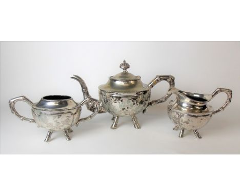 Chinese white metal three piece tea set, each with bamboo cast handles and four outswept feet, the circular section bodies en