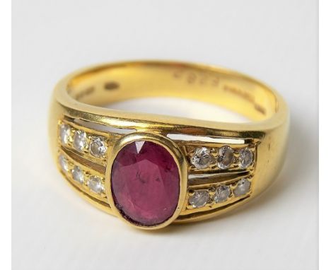 Modern 18ct gold ruby and diamond set ring, the oval cut ruby in collet setting of 0.75ct spread approx, flanked by two rows 