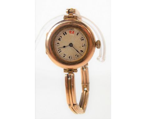 Early 20th Century 9ct gold ladies bracelet manual wind wristwatch, the 18mm circular silvered textured dial with Arabic Nume
