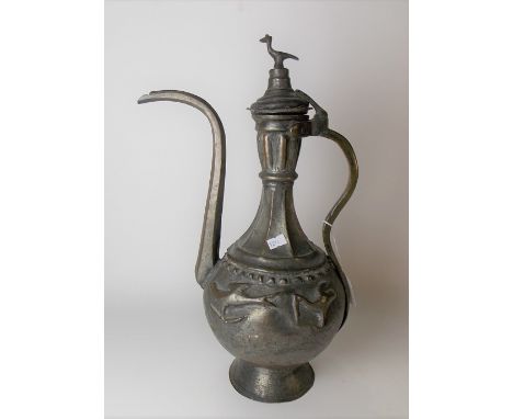 Middle Eastern tinned copper hinged lidded coffee pot, the lid with bird finial, the ovoid body embossed with four stylised b