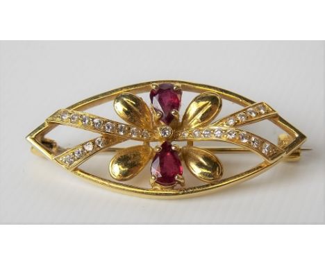 Attractive modern 18ct hallmarked gold ruby and diamond set brooch, the two rubies of pear-shaped cut and with twenty five sm