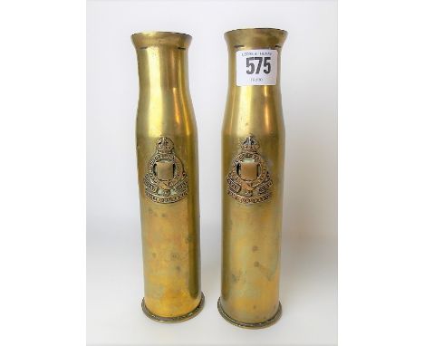 Pair of WWI trench art shell vases with applied military badge for Royal Army Ordnance Corps, height 22cm.