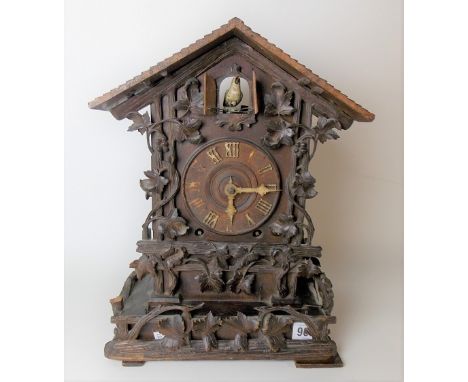 Blackforest carved two-train cuckoo mantel clock with 4in dial with carved bone hands &amp; Roman Numerals, the case carved w
