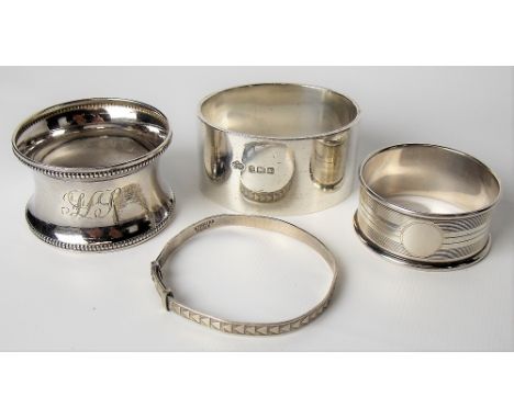 Three hallmarked silver napkin rings; together with a child's sterling silver bangle, weight overall 2.75oz approx (4).