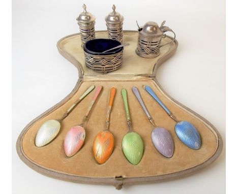 George V silver four piece cruet with pierced sides and blue glass liners; together with two salt spoons and a silver gilt co